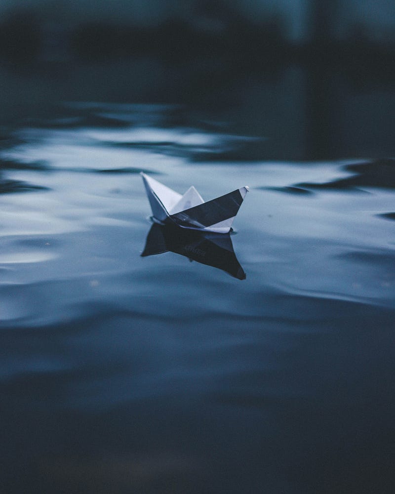 Paper boat navigating turbulent waters