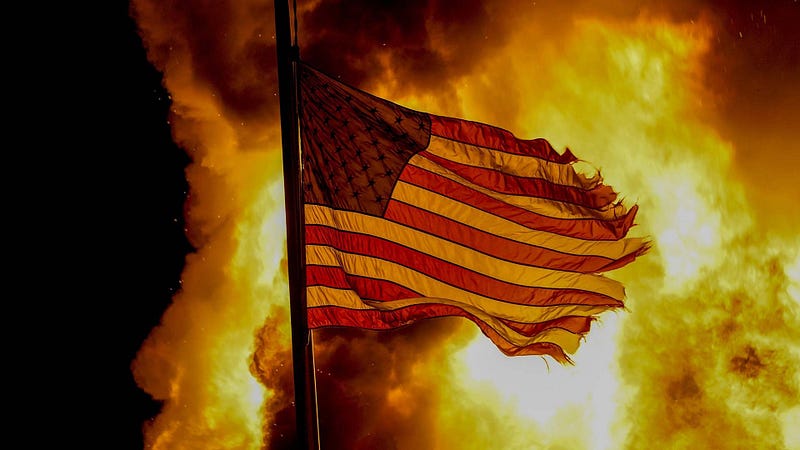 Flag outside a burning corrections facility during protests